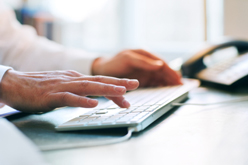 Hands typing on keyboard